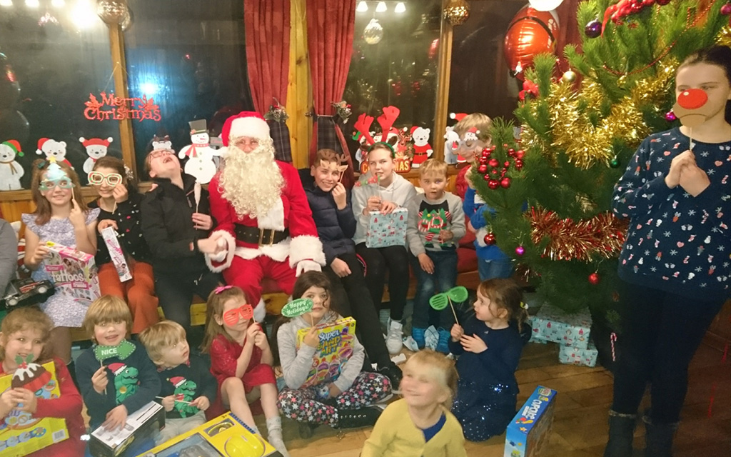 Santa giving out gifts at community event