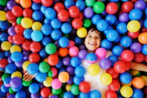 Child in a pool of play balls